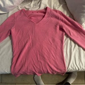 pink sweater. defines body shape well